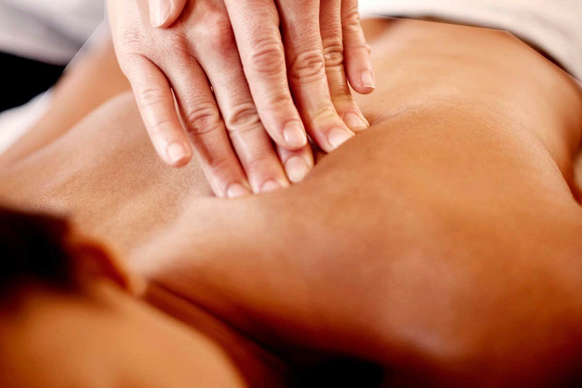 A person receiving a back massage.