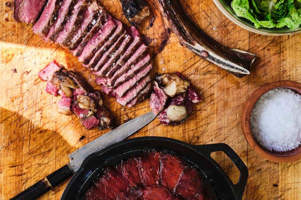 Cut meat and a red sauce on a wooden table. 