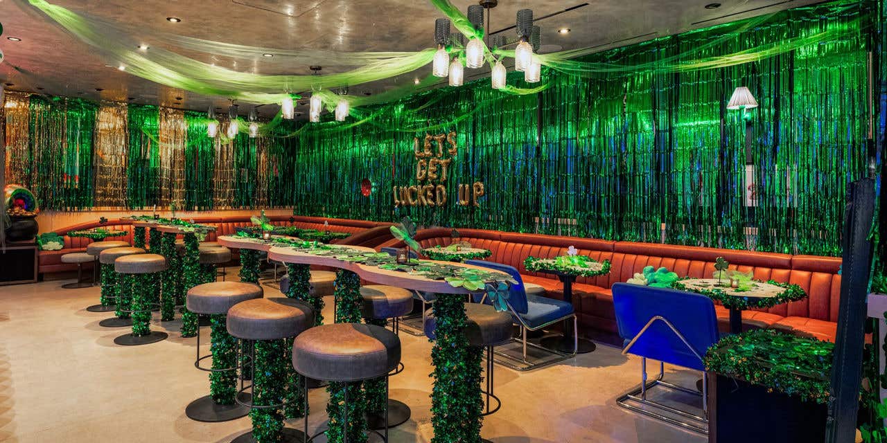 Lounge decorated with green streamers and themed table settings.