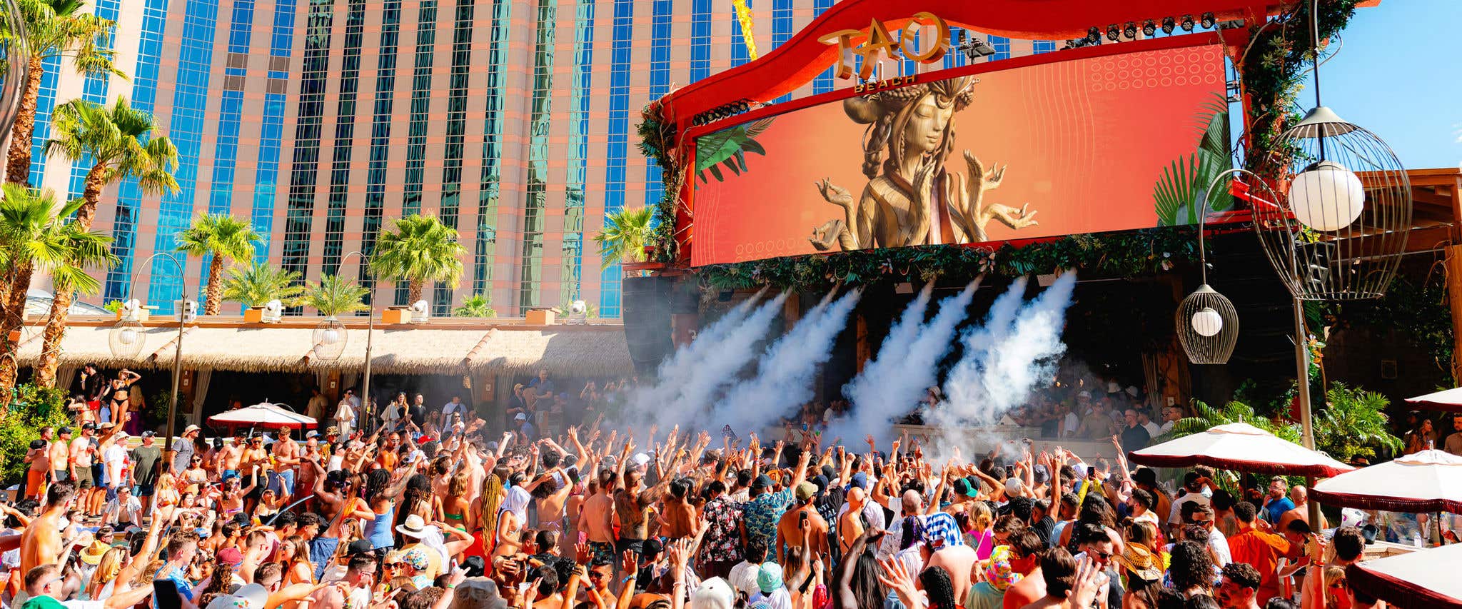 A crowd of people at TAO Beach dancing to the music. 