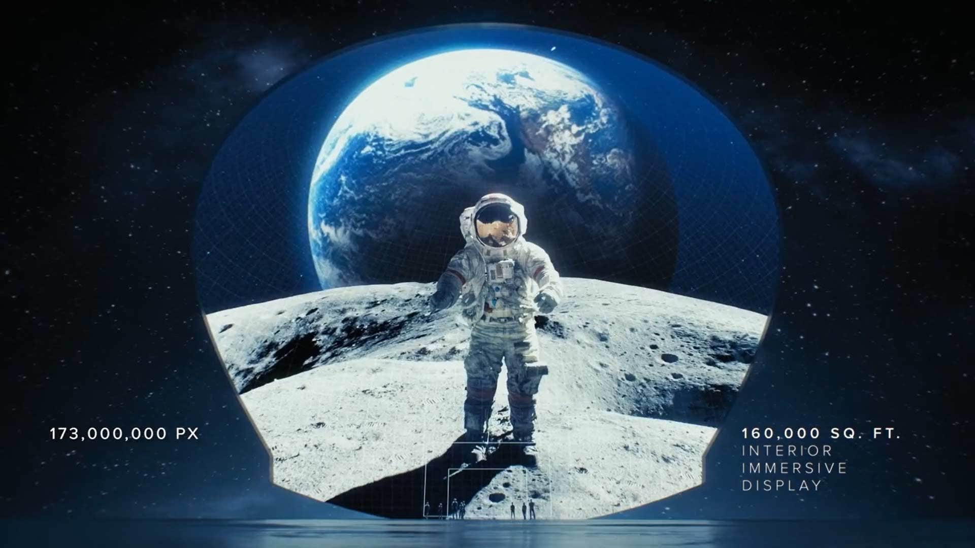 Astronaut standing on the moon with Earth in the background, inside a large dome display showing 173 million pixels.